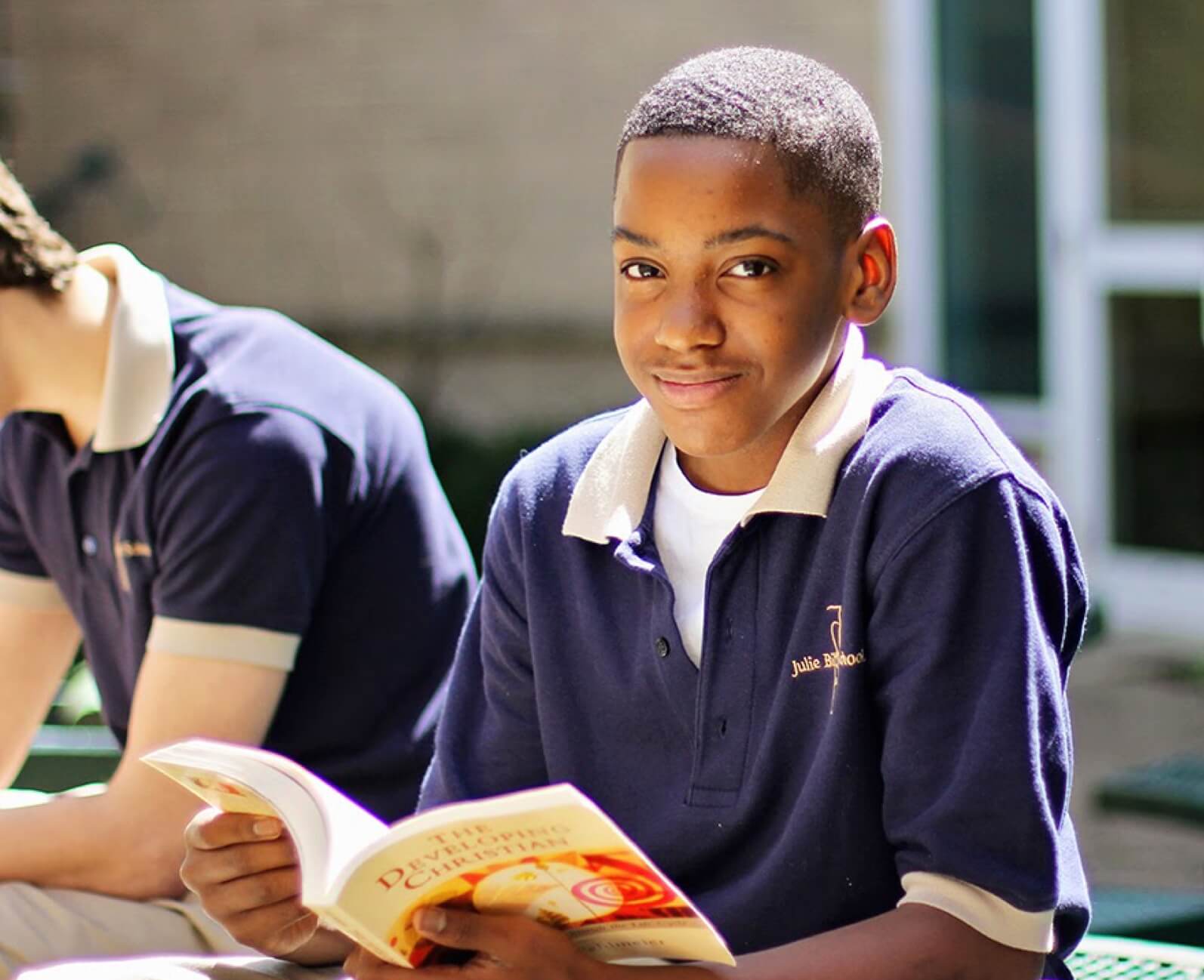 boy-smiling-holding-book